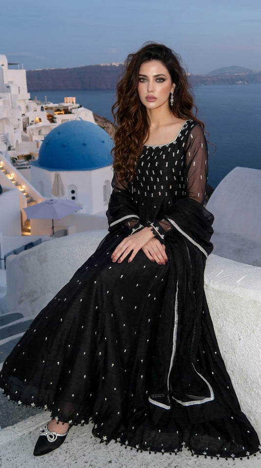Moonlight Black Maxi Dress - Seated Pose with Santorini Background | Armia Official